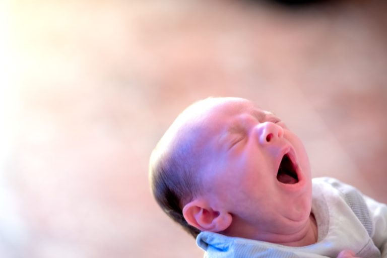 Newborn baby boy yawning. Relax concept